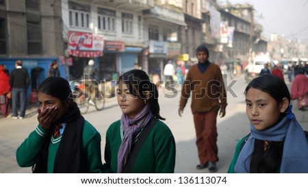 KATHMANDU, NEPAL - JANUARY 19: School girls wear the surgical mask in kathmandu on 19 Jan 2010. Children from poor families are leaving schools, as their parents can\'t afford to keep them in school
