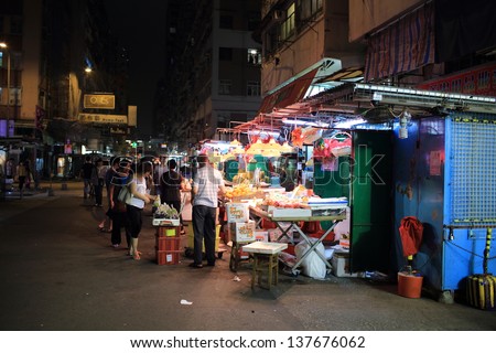 HONG KONG-APRIL 29:  the sidewalk fruit shop in Fa Yuen street at night on April 29 2013. it\'s retail street with shops and hawker stalls selling fruit, bargain-priced fashion and casual wear also.