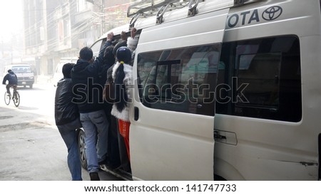KATHMANDU, NEPAL -JANUARY 29: the overload minibus on the road in kathmandu on 29 Jan 2013. minibus in kathmandu is main transportation.UN list Nepal as one of the Least developed country in the world