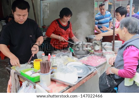 PUNING, CHINA - MARCH 17: the unidentified family sell the homemade shahe fen in the food store in Guangdong on March 17 2013. Shahe fen or he fen is a type of wide Chinese noodle made from rice