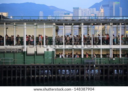 HONG KONG -JULY 20:passengers walk in the ferry pier and back home on July 14, 2013 in HK. Its principal routes carry passengers across Victoria Harbor, one of the tourist attraction in Hong Kong