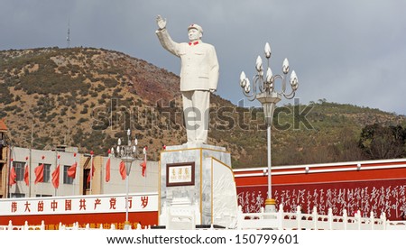 LIJIANG,CHINA-FEB 18:Mao statue,with the slogan on wall: \