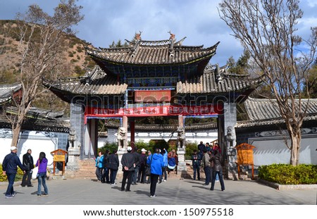 LIJIANG, CHINA -FEB 18: tourists stand in front of Black Dragon Pool garden in Lijiang old town on Feb 18 2012.As china economic growth, rural area develop tourism but culture invasion also occupied