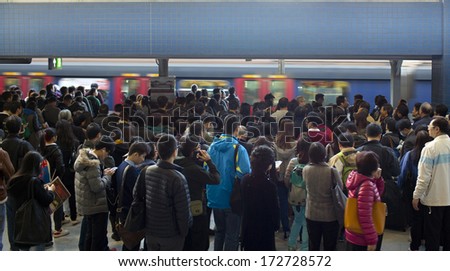 HONG KONG, NOVEMBER 29: crowd of passengers are waiting in Kowloon Tong station on 29 nov 2014. MTR is the main subway and train system in Hong Kong, and one of large transport networks in Asia