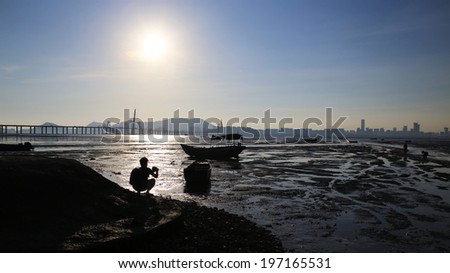Photographer take photo in Ha Pak Nai wetland after tidal wave , the oyster field scenes from hong kong to shenzhen coast at Ha Pak Nai, Yuen Long china
