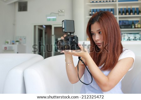 Girl try to take pic by her old retro camera, focus on someone / something