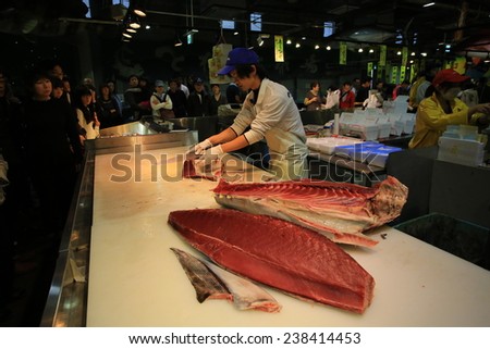 SHIRAHAMA,JAPAN, NOV. 22: fish worker fillet the Tuna ,make a auction at tore tore fish market in shirahama on 22 November 2014. as the growth of sushi and sashimi demand, the species is overfished