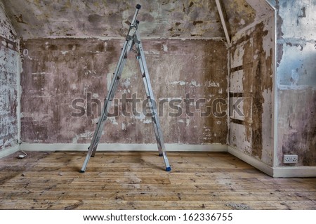 Stepladders in a room that is being decorated with textured stripped drywall/plasterboard walls.