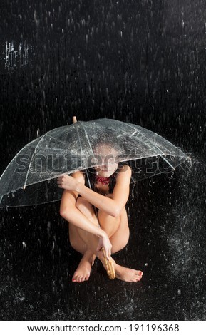 Happy girl with rain and transparent umbrella