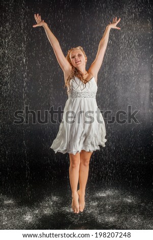 Blonde girl in dress in water studio