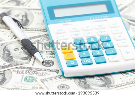 Concept of business money, calculator and pen.