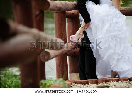 Leg in the pink shoe of a bride in assumptions of the husband