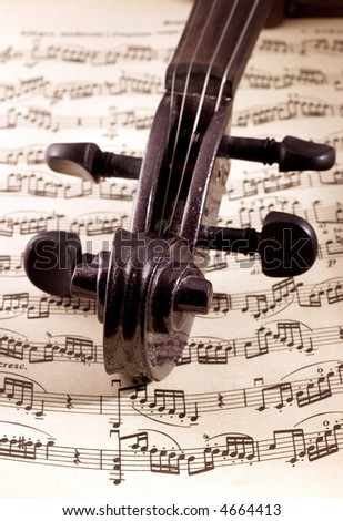 close-up of black violin on music sheet