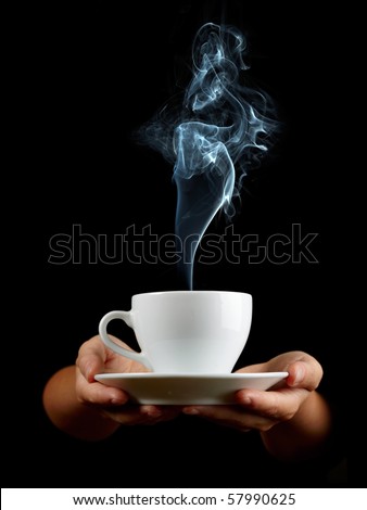 Cup of coffee in the women\'s hand on black background