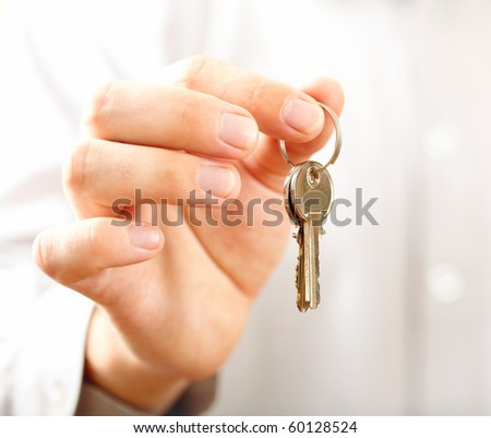 Man holding key. Shallow DOF, focus on key