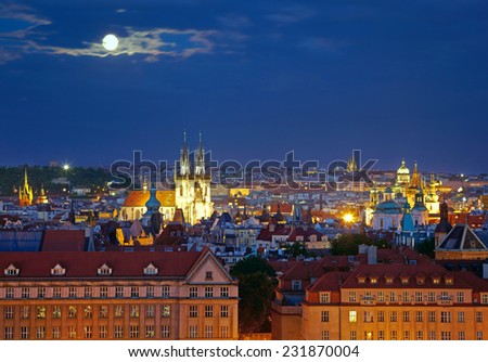 Prague cityscape at night time with full moon