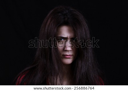 Violence-Unhappy ,Sad woman  on black background.Dark portrait