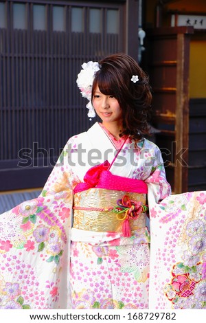 KYOTO, JAPAN - OCTOBER 14:Young model poses for a photographer with kimono on October 14,2013 in Kyoto.