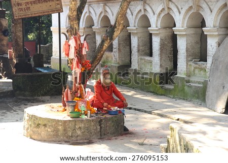 NEPAL-OCTOBER 04, 2012: Mystic Man praying with offerings in a city square on October 04, Nepal.