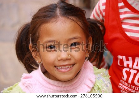 KATHMANDU,NEPAL-OCTOBER 16, 2012: Nepalese child observes with curiosity to tourists on October 16, Nepal.