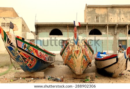 SAINT LOUIS DU SENEGAL,SENEGAL-APRIL 19,2014: The local people fish on the beach between canoes and horses on April 19, in Saint Louis du Senegal.