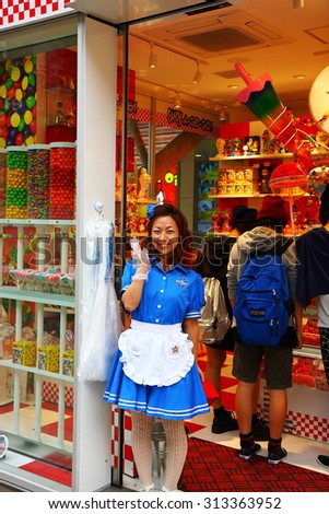 TOKYO,JAPAN - OCTOBER 09: Sympathetic clerk greets visitors at the door of the store on October 09,2013 in Tokyo.