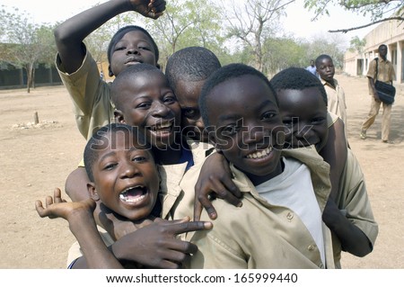 KOUPELA, BURKINA FASO - FEBRUARY 20 : A small group of pupils of the college Saint-Philippe have fun much to be photographed together, February 20, 2007