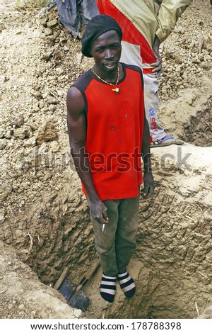 BOLOGO, BURKINA FASO - JANUARY 11: Gold Miner african pausing to smoke his cigarette gold mine where he works, january 11, 2008.