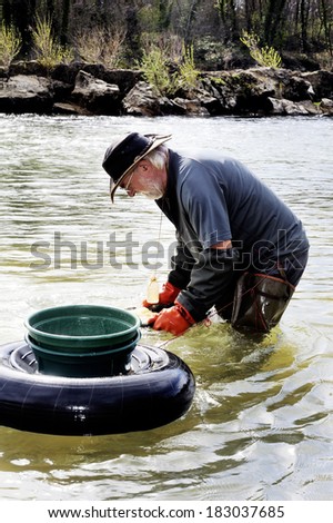 BOUCOIRAN, FRANCE - MARCH 16; Gold digger in France in the region of Cevennes and the department of Gard in the middle of the river called Le Gardon, march 16, 2014