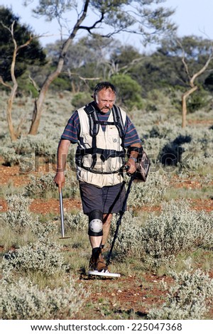 AUSTRALIA - MAY 10: Gold miner in the Australian outback prospecting area in the bush with his metal detector looking for gold nuggets, may 10, 2007.