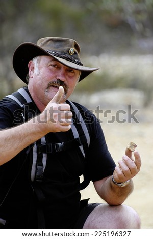 AUSTRALIA - APRIL 24: A gold miner in Australia happy to have found a piece of quartz containing gold, April 24, 2007