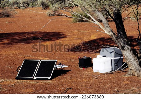 Camping solar panels installed in Australia for recharging batteries and powering a refrigerator travel