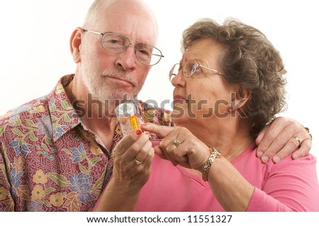 Senior Couple reads a prescription bottle.