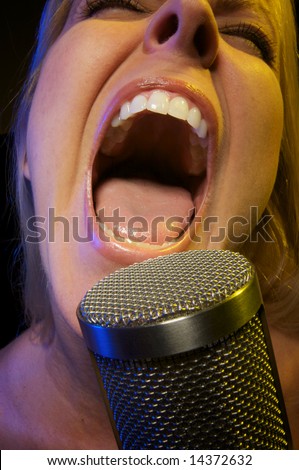 Woman with Microphone Sings with Passion