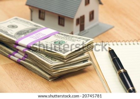 House and Money with Pad of Paper and Pen