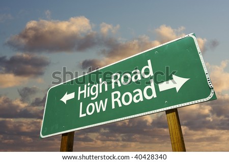 High and Low Road Green Road Sign with dramatic blue sky and clouds.