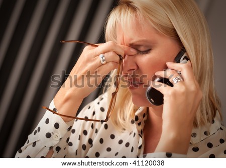 Blonde Woman on Her Cell Phone with Stressed Look on Her Face.