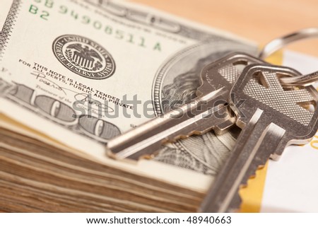 House Keys on Stack of Money - Cash for Keys Program.