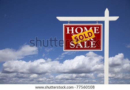 Red Sold Home For Sale Real Estate Sign Over Beautiful Clouds and Blue Sky.