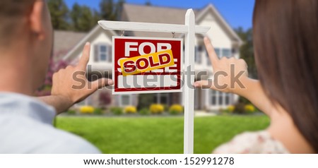 Sold For Sale Real Estate Sign, House and Military Couple Framing Hands in Front.