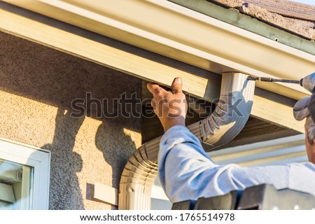 Worker Attaching Aluminum Rain Gutter and Down Spout  Сток-фото © 