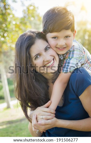 Attractive Young Mixed Race Mother and Son Hug Outdoors in the Park.