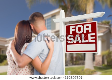 For Sale Real Estate Sign and Military Couple Looking at Nice New House.