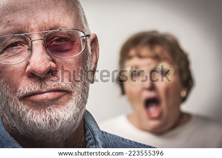 Battered and Scared Man with Screaming Angry Woman Behind.