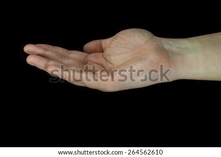 Cupped human hand isolated on black background.