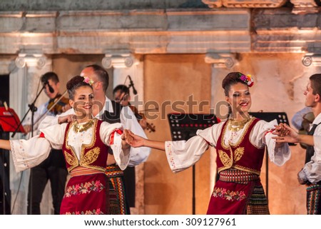 PLOVDIV, BULGARIA - AUGUST 06, 2015 - 21-st international folklore festival in Plovdiv, Bulgaria. The folklore group from Serbia dressed in traditional clothing is preforming Serbian national dances.