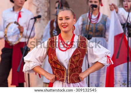 PLOVDIV, BULGARIA - AUGUST 06, 2015 - 21-st international folklore festival in Plovdiv, Bulgaria. The folklore group from Poland dressed in traditional clothing is preforming Polish national dances.