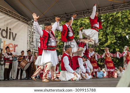 PLOVDIV, BULGARIA - AUGUST 06, 2015 - 21-st international folklore festival in Plovdiv, Bulgaria. The folklore group from Bulgaria dressed in traditional clothing is preforming national dances.