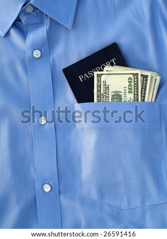 passport and us currency in the pocket of a button down shirt
