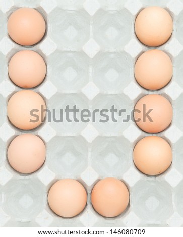 letter v  from the eggs,Eggs in paper tray isolated on white